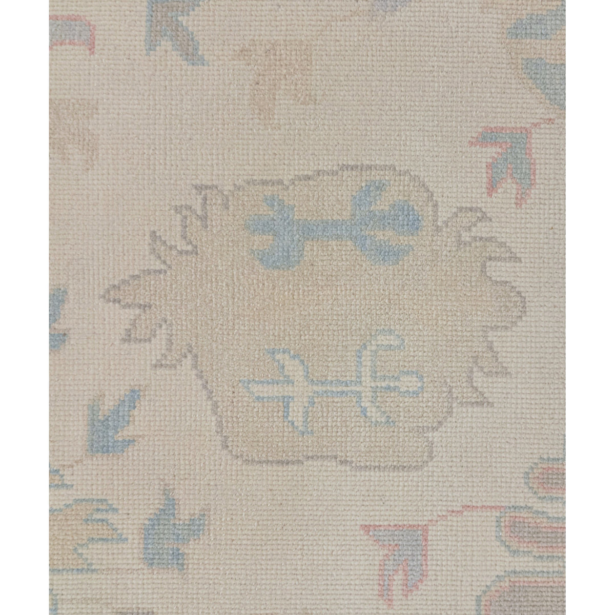 Beige rug with decorative patterns on a plain background