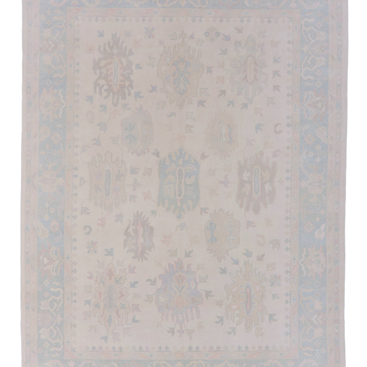 Beige area rug with subtle pattern on a plain background
